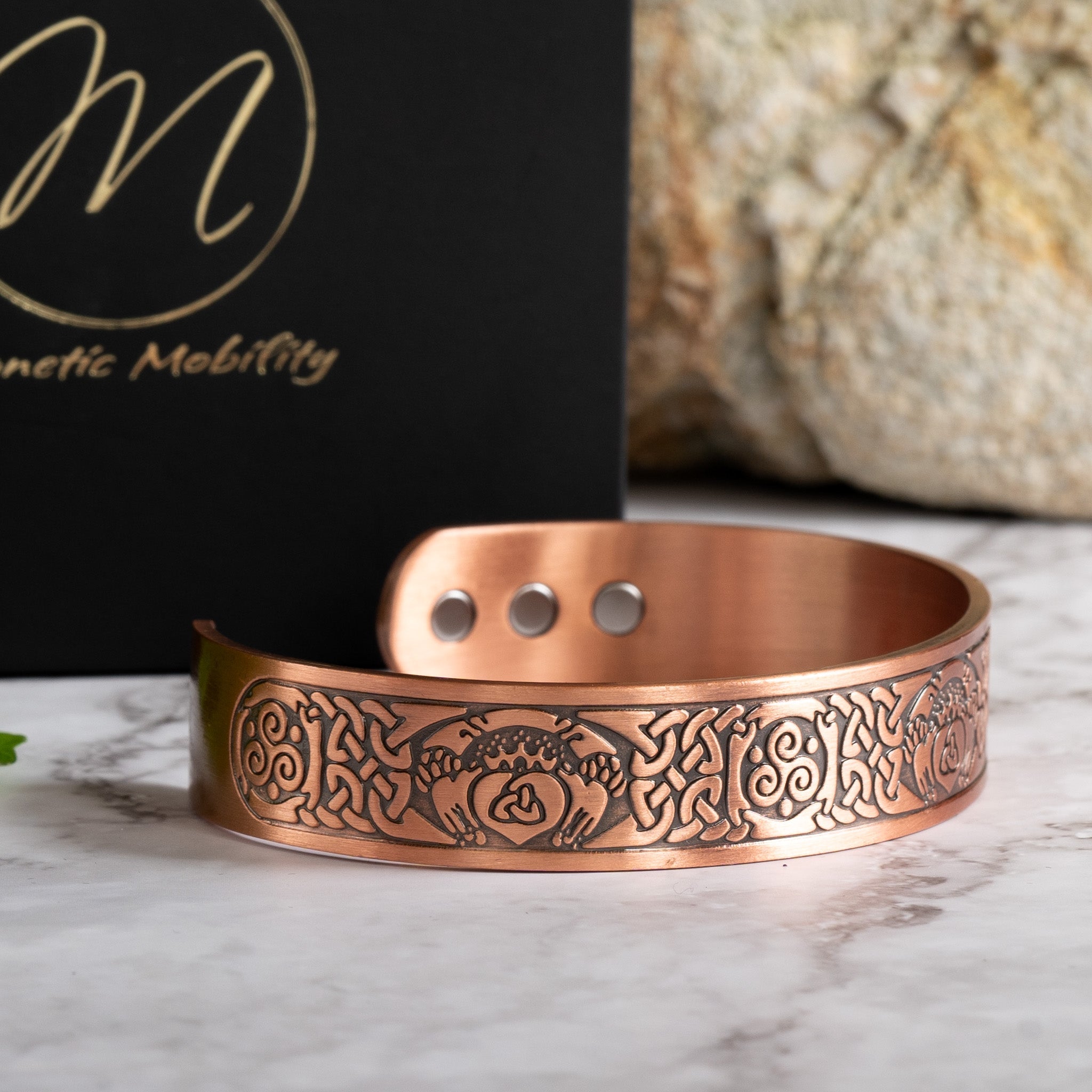Magnetic Mobility Claddagh Ireland Copper Magnetic Bracelet – presentation view – bracelet with branded black gift box and seasonal decor.
