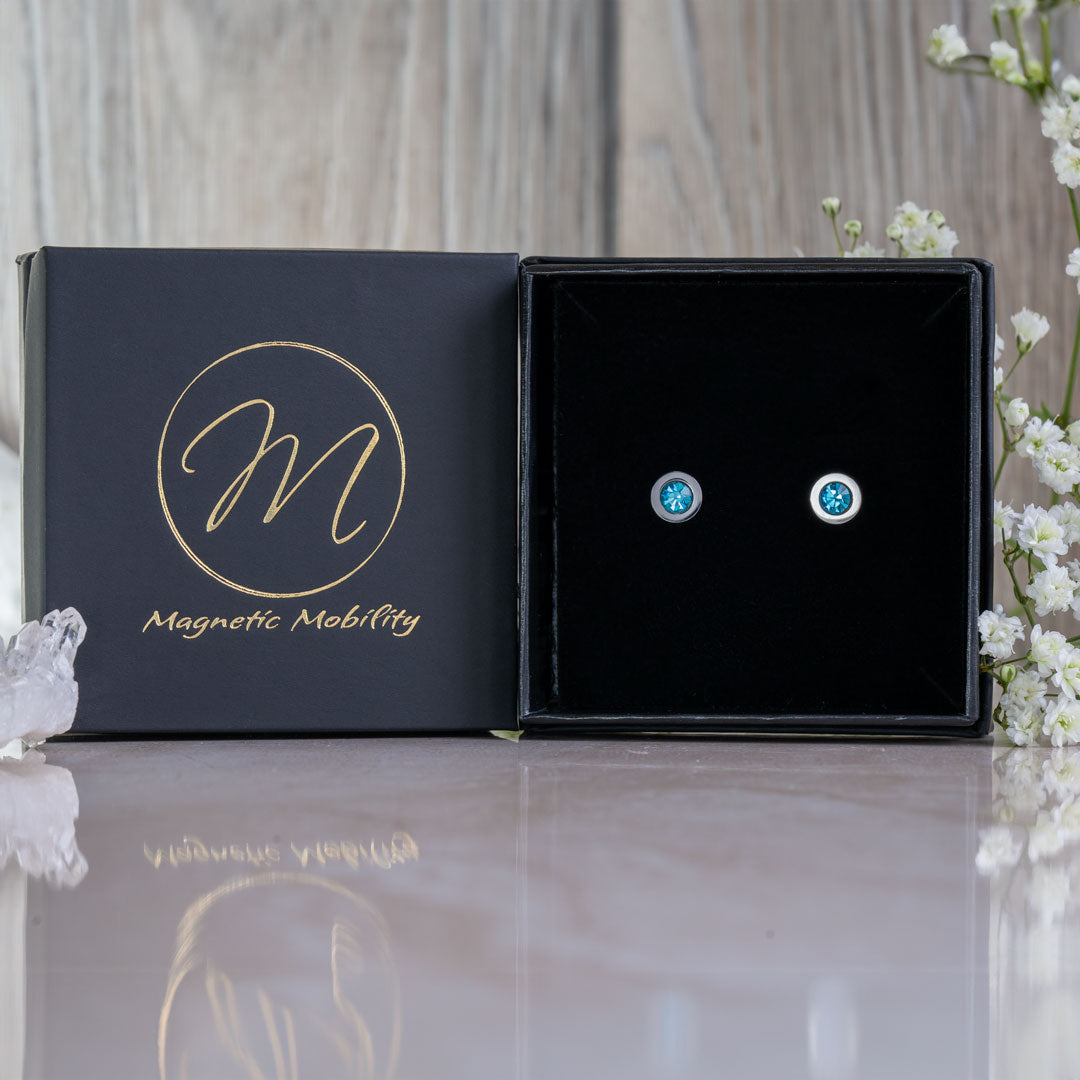 Magnetic Mobility Birthstone Magnetic Stud Earrings – March Aquamarine variant – polished stainless steel setting with blue Swarovski crystal.