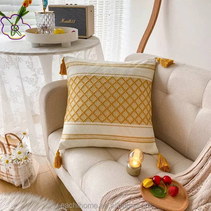 Moroccan Boho Tufted Tassel Cushion Cover 45x45cm - Mustard yellow and white tufted cushion cover with corner tassels displayed on a beige sofa
