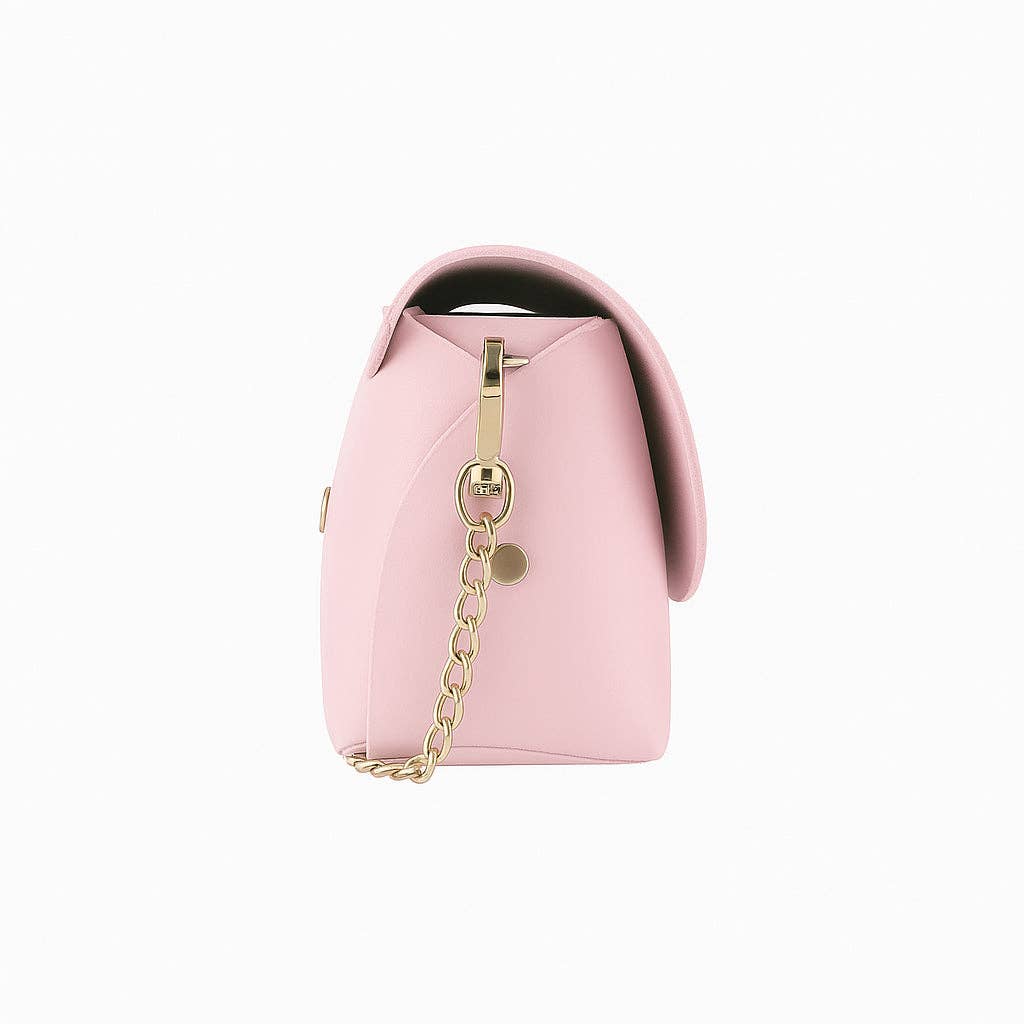 Side profile of pink leather mini bag showing depth and gold D-ring hardware